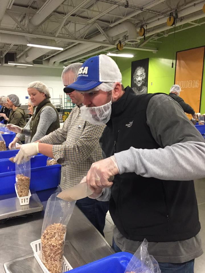 Volunteer helps box food